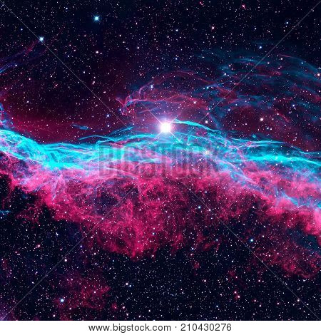 The Veil Nebula or The Witch's Broom Nebula is a cloud of heated and ionized gas and dust in the constellation Cygnus. Retouched colored image. Elements of this image furnished by NASA.