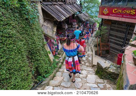 Tourists In Traditional Clothes In Catcat Ethnic Village