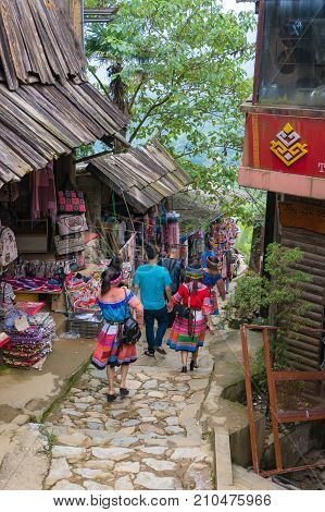 Tourists In Traditional Clothes In Catcat Ethnic Village