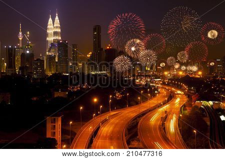 The capital of Malaysia, Kuala Lumpur city skyline night view with fireworks over the sky.