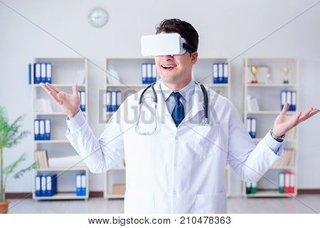 Young doctor with vr virtual reality headset working in the offi