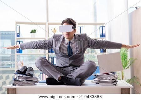 Businessman with VR virtual reality glasses in office