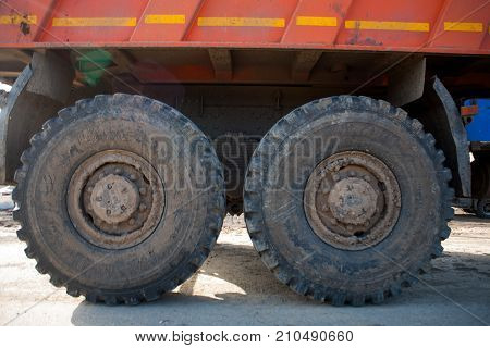 big wheels of a heavy truck in the mud
