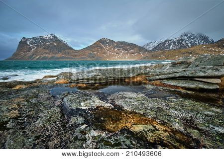 Rocky coast of fjord of Norwegian sea in winter. Lofoten islands, Norway