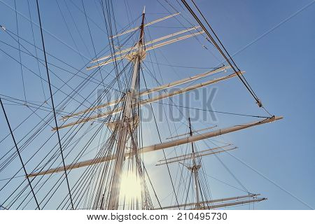 Ship masts in glowing highlights
