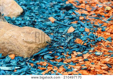 Painted decorative wooden sawdust is orange and blue.