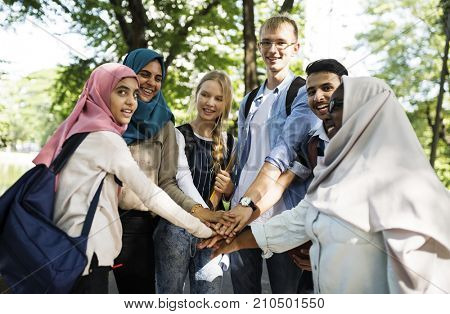 Group of diverse youth with teamwork joined hands