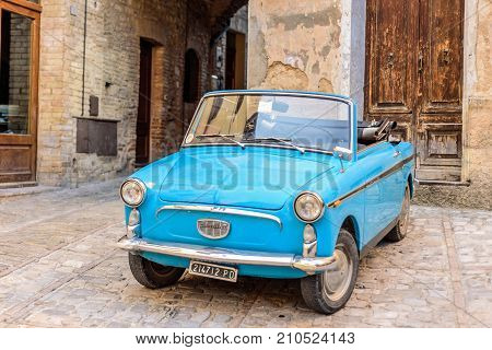 SPELLO, ITALY - MAY 27 2017 - An italian vintage car parked in a street of the historical center of Spello in Umbria