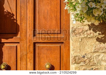 Close up of a wooden door with white flowers