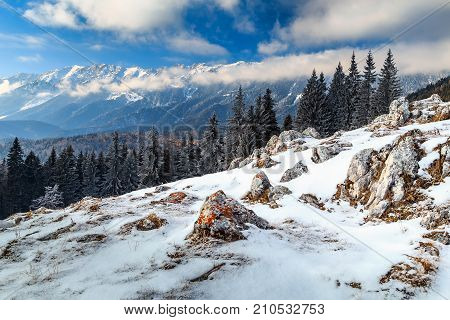 Stunning winter landscape with cloudy sky and high mountains in backgroundPiatra Craiului mountainsCarpathiansTransylvaniaRomaniaEurope
