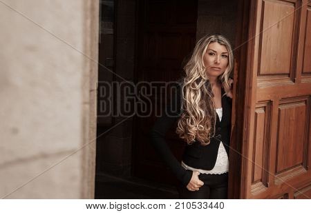 Beautiful Girl Peeks Through The Door, Peeking Out Of Doorway. Girl With Low Lighting, A Massive Doo