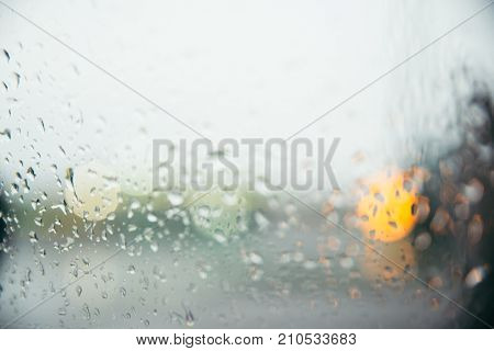 drops on the window with the background of the city lights