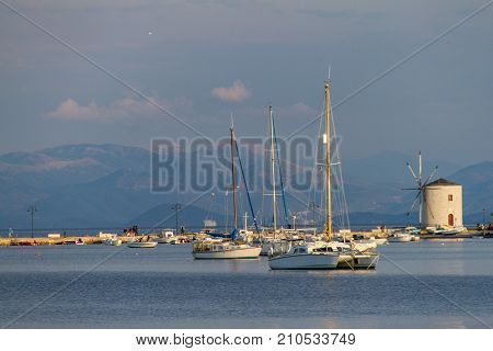 Sail-boats and WIndmill at the seafront of Corfu city island of Corfu in Greece