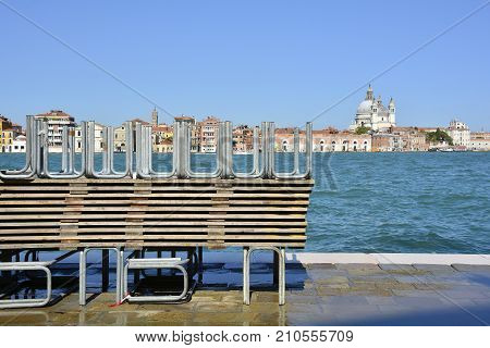 A pile of temporary walkways which are used during the regular acqua alta / high water flooding in Venice. Photo taken from the island of Giudecca looking towards Dorsoduro with the church of Santa Maria Della Salute (Saint Mary of Health) in the backgrou
