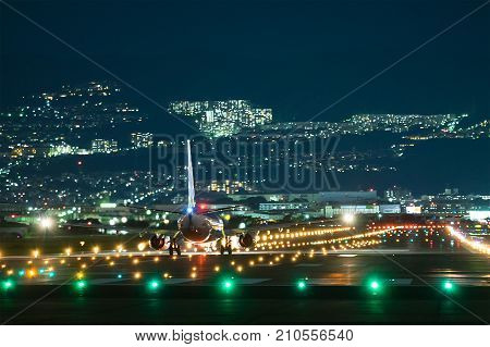 OSAKA, JAPAN - Aug. 13, 2017: Boeing airplane taking off from the Itami International Airport in Osaka, Japan in the night.
