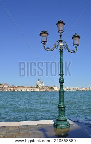 A view of the island of Dorsodoro in Venice taken from the island of Giudecca across the Giudecca Canal. The church of Santa Maria Della Salute (Saint Mary of Health) can be seen towering above the other buildings