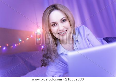 I feel amazing. Beautiful dark-eyed young woman smiling and feeling happy and her eyes shining