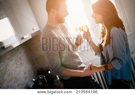 Young couple in love celebrating moving into new home with champagne