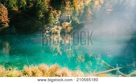 Autumn time at romantic forest lake Blausee, one of the best known mountain lakes in Switzerland.