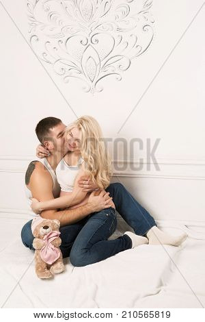 Beautiful pregnant couple in love on the background. Hands of husband on the tummy of his pregnant wife. Young man tenderly stroked pregnant belly of his wife. Husband kissing pregnant belly.