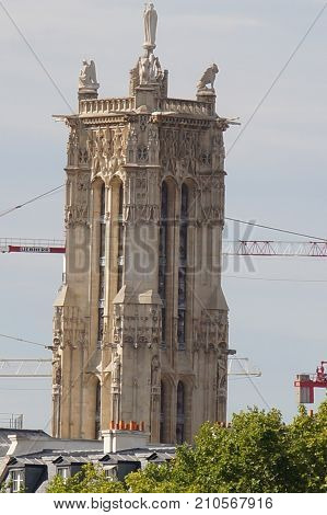 The tower Saint Jacques - Paris, France. The tower Saint Jacques is an isolated tower, built between 1509 and 1523, raised (drawn up) in the middle of the first Parisian public garden, which bears its name, in 4 District of Paris.
