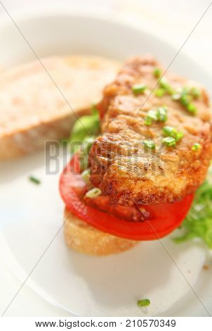 A Battered And Fried Pork Cutlet With Tomato Chopped Lettuce And Scallions On Artisan Bread