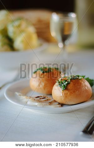 Ukarnian food - round pastries pampushki on ceramic plate