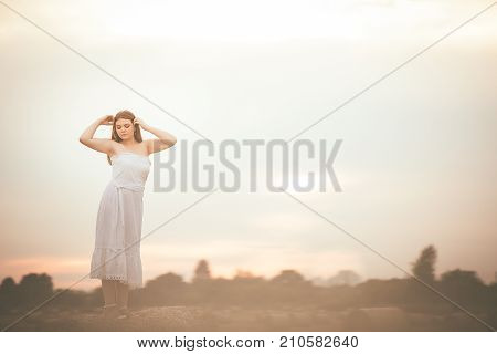 Beautiful Girl On Hay Bales In The Fields
