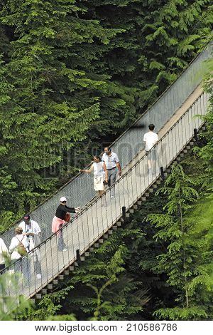VANCOUVER, CANADA - JULY 2, 2007: Visitors exploring the Capilano Suspension Bridge in Capilano Park Treetops Adventure.