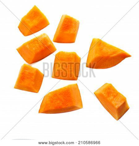 Pumpkin pieces cut in a cube slice isolated on white background. Diced Pumpkin close up.