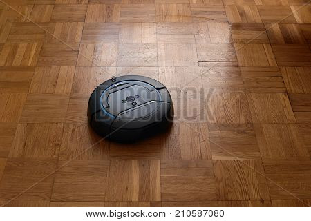 Modern smart electronic automatic robovac cleaning the room