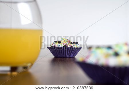 Tasty cupcakes on a white wooden table