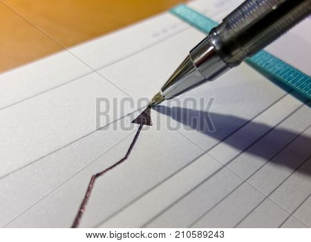 Gel pen draws a graph of positive growth up
