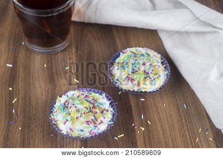 Tasty cupcakes on a white wooden table