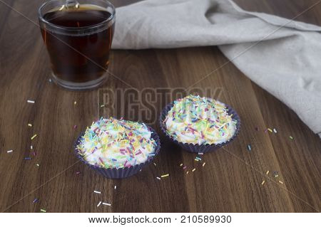 Tasty cupcakes on a white wooden table