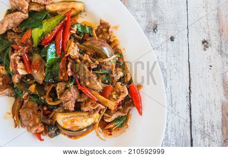 Stir Fried Wild Boar with Red Curry thai food concept on wooden table background.