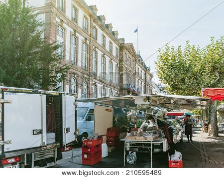 STRASBOURG FRANCE - SEP 22 2017: Meat delicatessen stall at a Saturday farmer's market in place Broglie Strasbourg in front of the City Hall