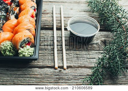 On A Wooden Table Lay In The Black Sushi Container