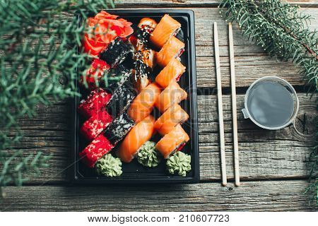 On A Wooden Table Lay In The Black Sushi Container