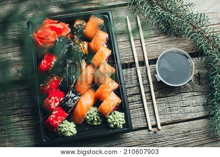On A Wooden Table Lay In The Black Sushi Container