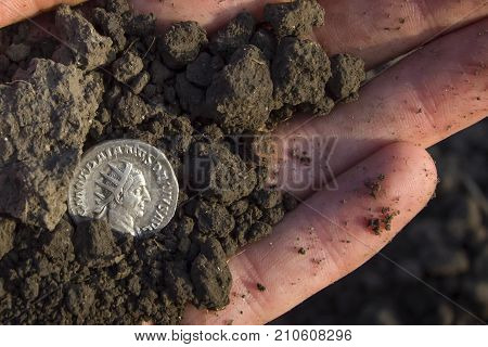 Hand Holding Roman Denarius (roman Silver Coin)