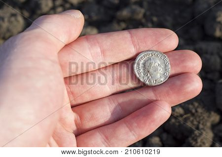 Hand Holding Roman Denarius (roman Silver Coin)