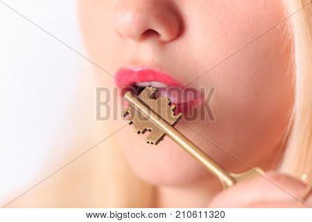 Old key near red sexy lips close-up. Language barrier or secret concept