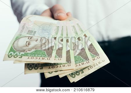 Businessman with hryvnia in his hands UAH