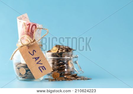 saving money in jar and jar of coins