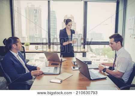 Businesswoman Presentation To A Group In Meeting.