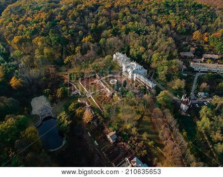Aerial view on abandoned ruined castle and park. Autumn color image in sunset light.