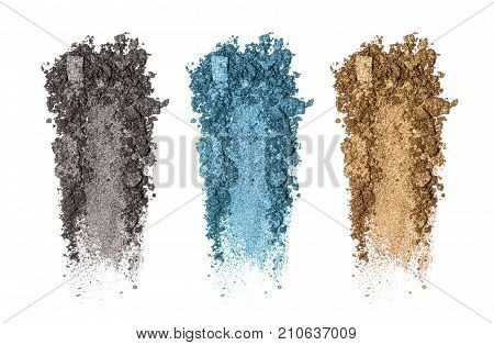 Set of eyeshadow sample isolated on white background. Crushed brown golgen, black and blue metallic eyeshadow. Closeup of a makeup product