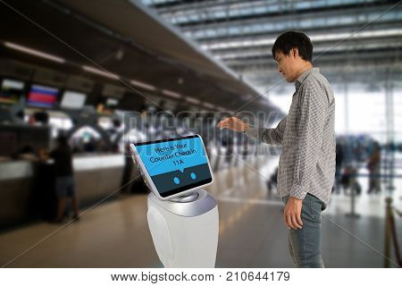 Smart robotic technology concept The passenger follow a service robot to a counter check in in airport the robot can help and give some information to passenger quickly