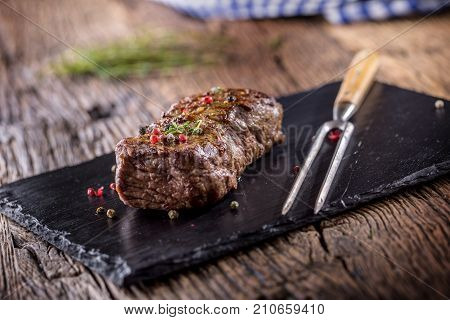 Beef Steak. Roasted Beef Steak With Salt Pepper Thyme On Rustic Wooden Table